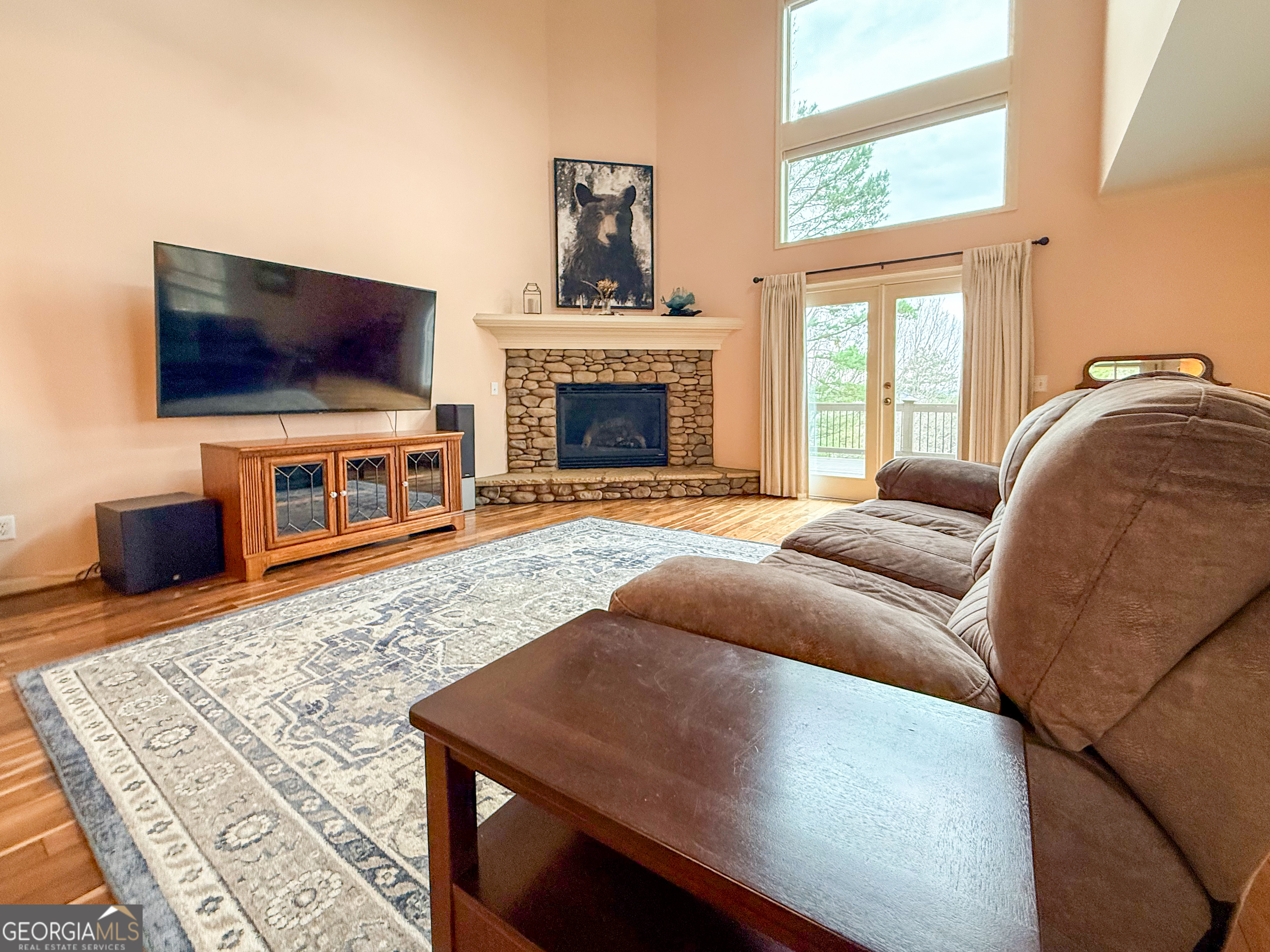 406 Yonah Mountain Road Cleveland, GA 30528 - Photo 5 of 65 a living room with a couch a flat screen tv and a fireplace