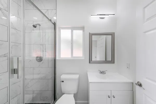 a bathroom with a toilet sink shower and mirror