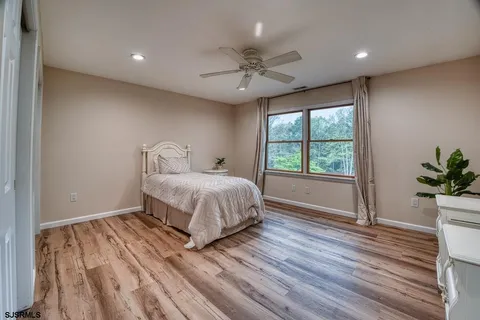 a white toilet sitting next to a bathroom sink and vanity