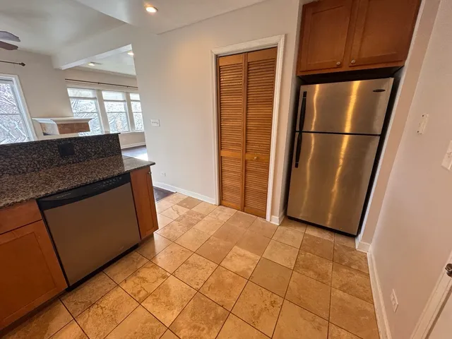 a kitchen with granite countertop a refrigerator and a stove