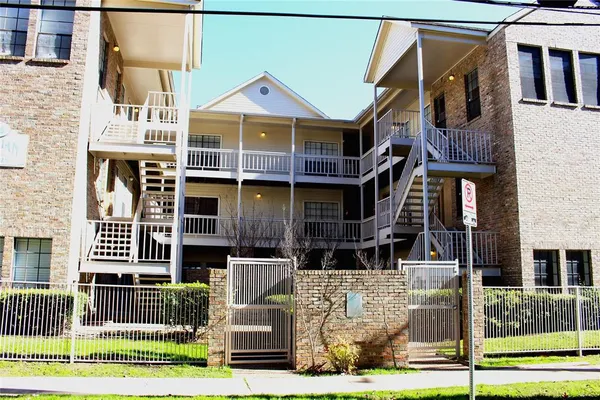 a front view of a residential apartment building with a yard