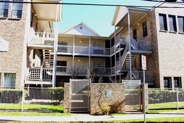 a front view of a residential apartment building with a yard