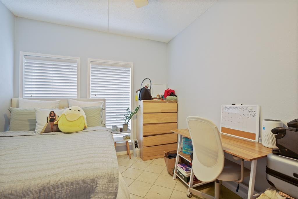 715 West 22 1/2 Street, Unit 101 Austin, TX 78705 - Photo 11 of 13 a bedroom with a bed and a lounge chair