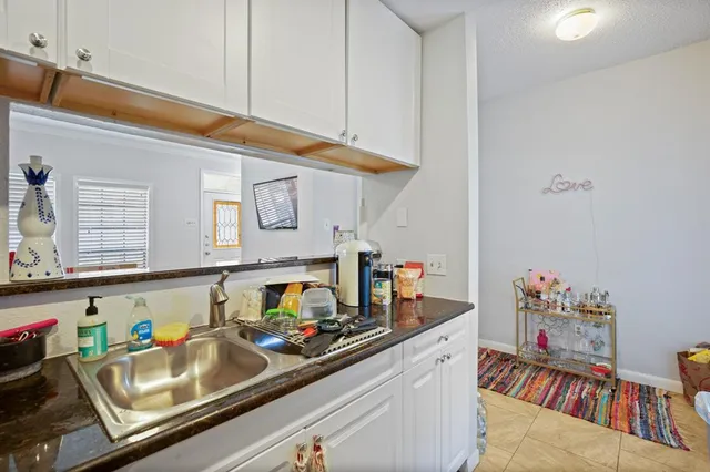 a kitchen with a sink appliances and cabinets