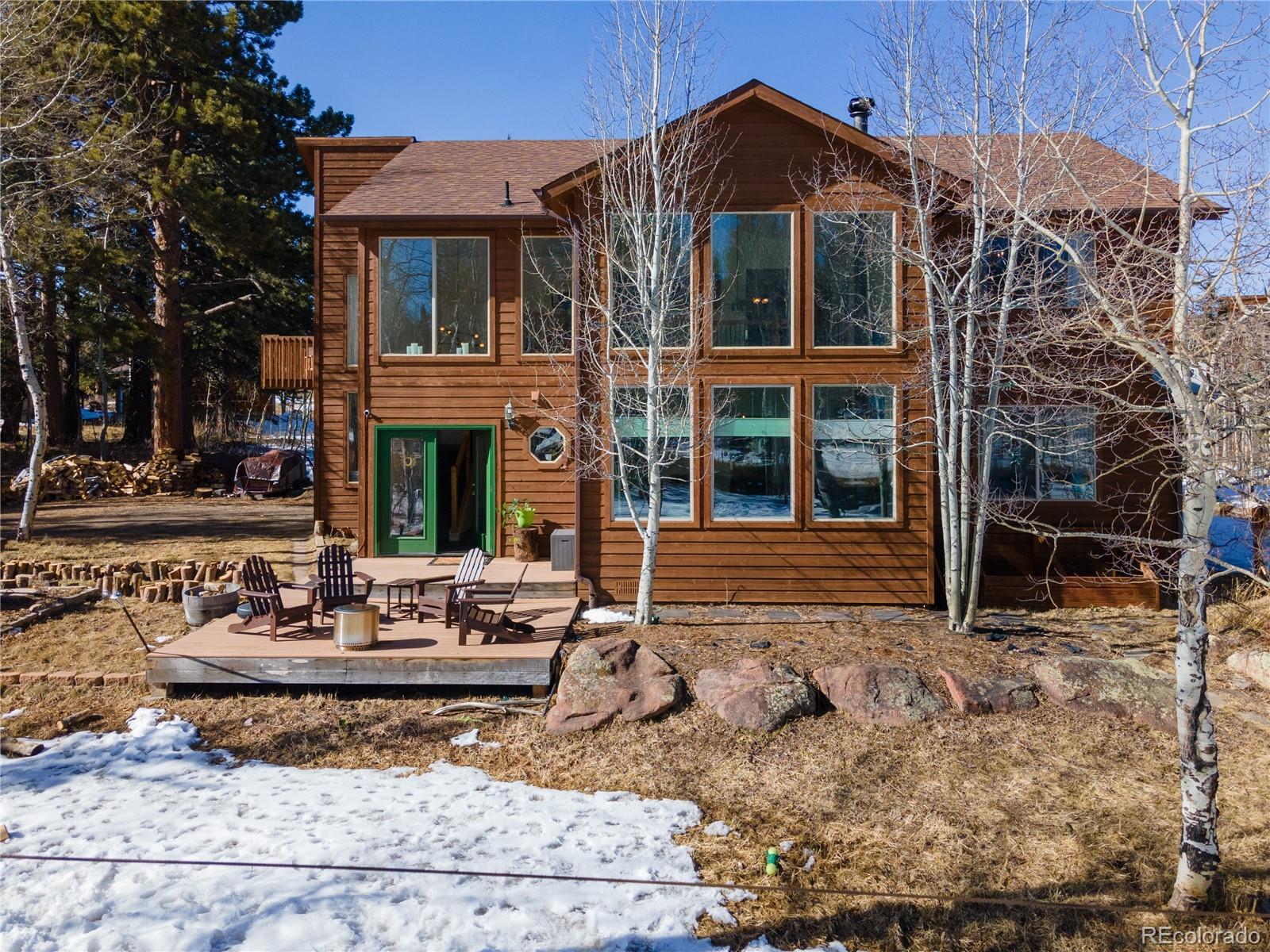 186 Thunder Ridge Road South Nederland, CO 80466 - Photo 1 of 50 a view of a brick house with many windows