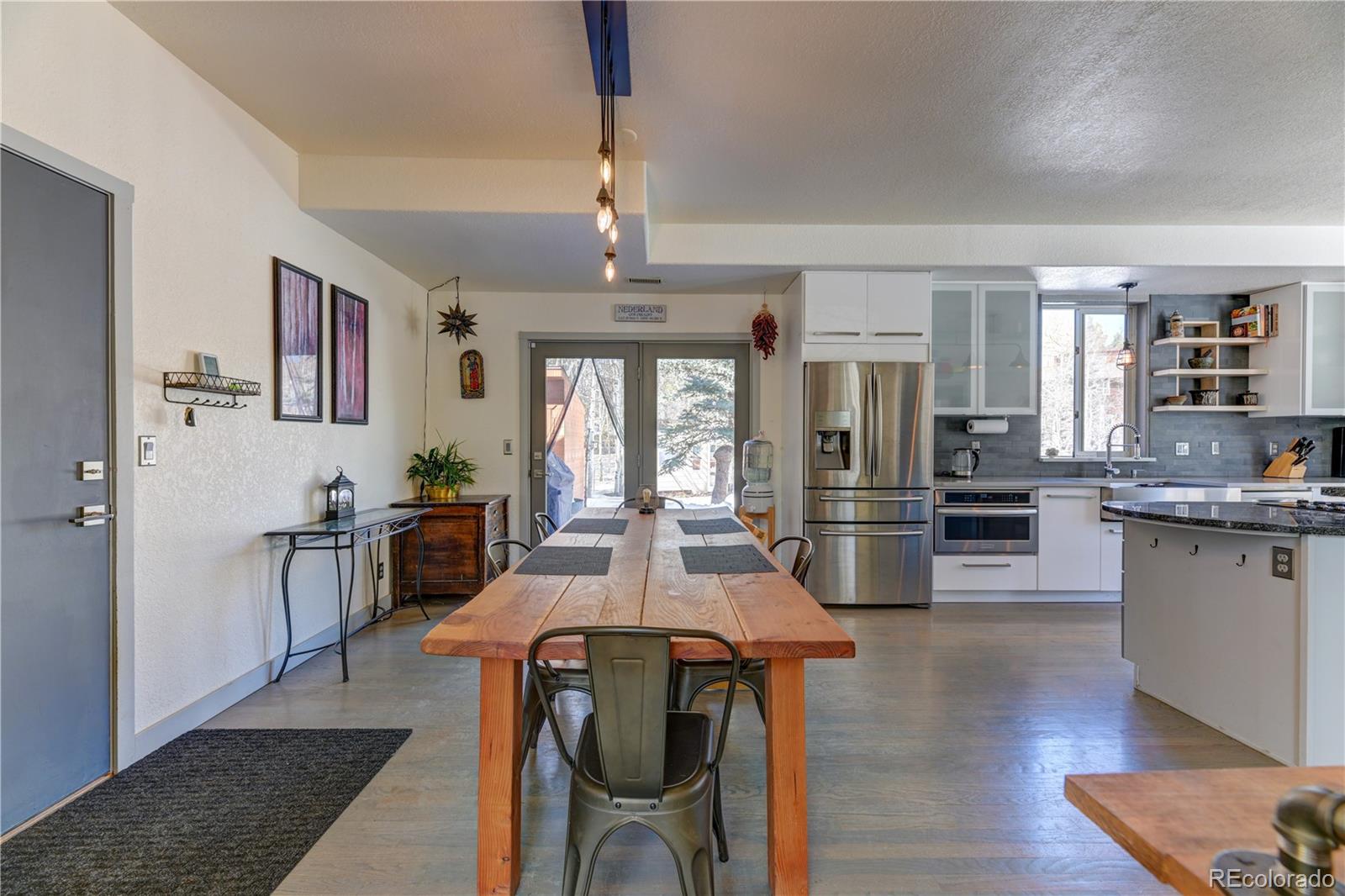 186 Thunder Ridge Road South Nederland, CO 80466 - Photo 25 of 50 a view of a dining room with furniture window and wooden floor