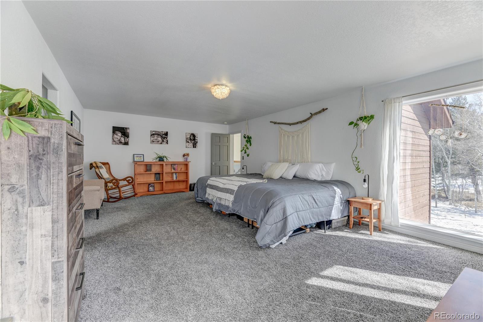 186 Thunder Ridge Road South Nederland, CO 80466 - Photo 33 of 50 a spacious bedroom with a bed and a window