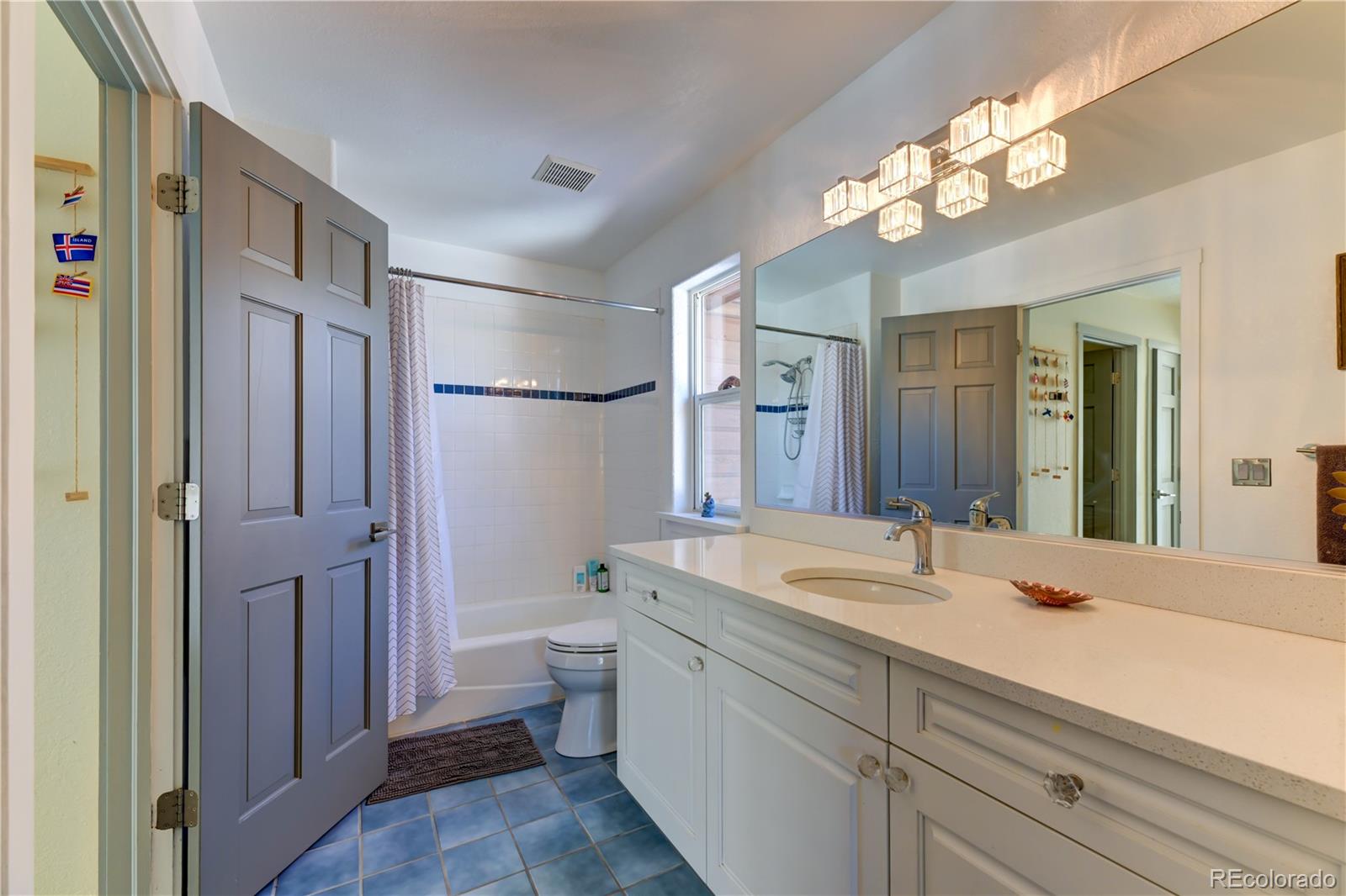 186 Thunder Ridge Road South Nederland, CO 80466 - Photo 39 of 50 a bathroom with a sink a toilet a large mirror and shower