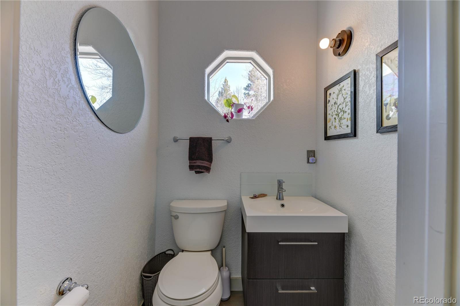 186 Thunder Ridge Road South Nederland, CO 80466 - Photo 40 of 50 a bathroom with a toilet and a sink
