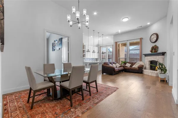 a living room with furniture a fireplace and a chandelier