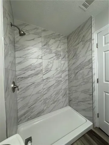 a bathroom with a shower and a toilet