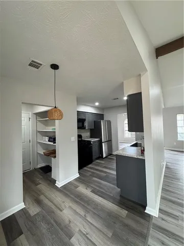 a view of a living room with furniture and a flat screen tv