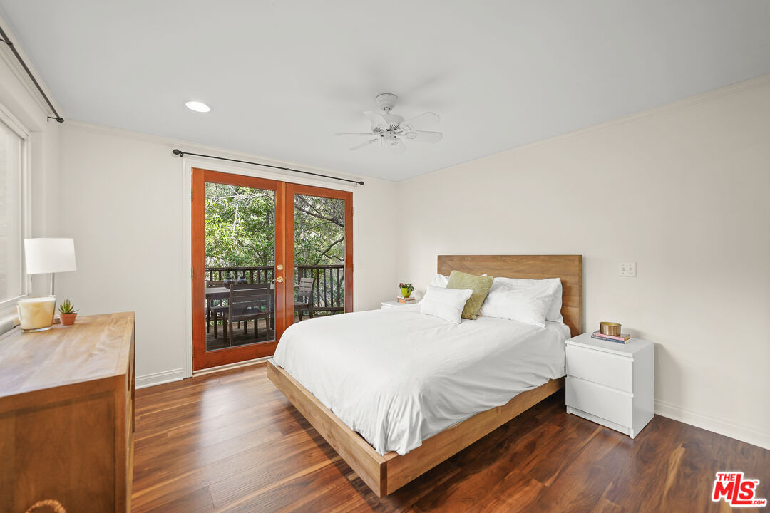 21545 Dome Trail Topanga, CA 90290 - Photo 12 of 23 a large bedroom with a bed and wooden floor