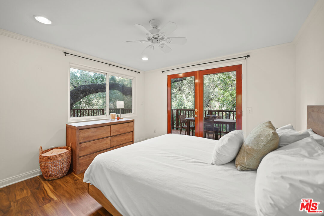 21545 Dome Trail Topanga, CA 90290 - Photo 13 of 23 a bedroom with a large bed and a large window