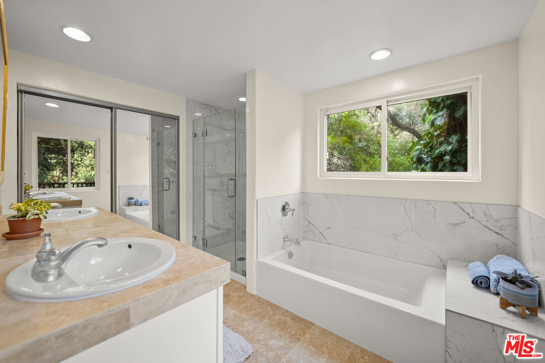 21545 Dome Trail Topanga, CA 90290 - Photo 14 of 23 a bathroom with a tub a sink and a window
