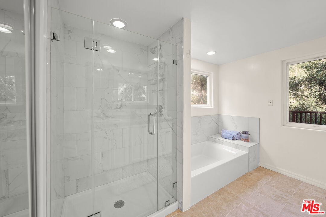 21545 Dome Trail Topanga, CA 90290 - Photo 15 of 23 a bathroom with a bathtub and shower