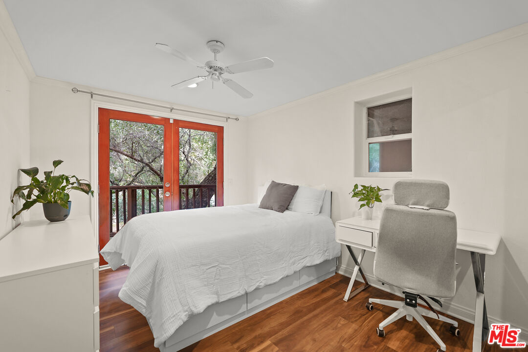 21545 Dome Trail Topanga, CA 90290 - Photo 16 of 23 a bedroom with a bed table chair and a window