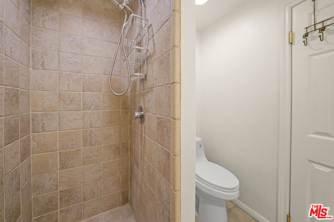 21545 Dome Trail Topanga, CA 90290 - Photo 18 of 23 a bathroom with a toilet and shower