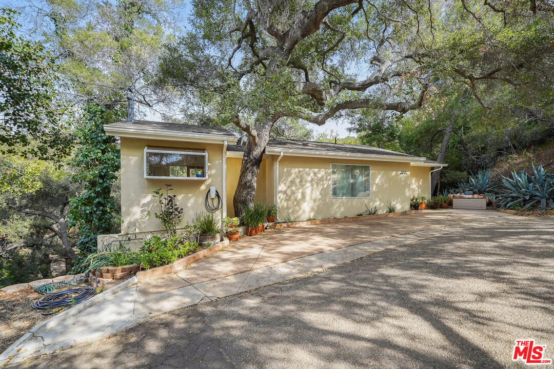 21545 Dome Trail Topanga, CA 90290 - Photo 22 of 23 a front view of a house with a garden