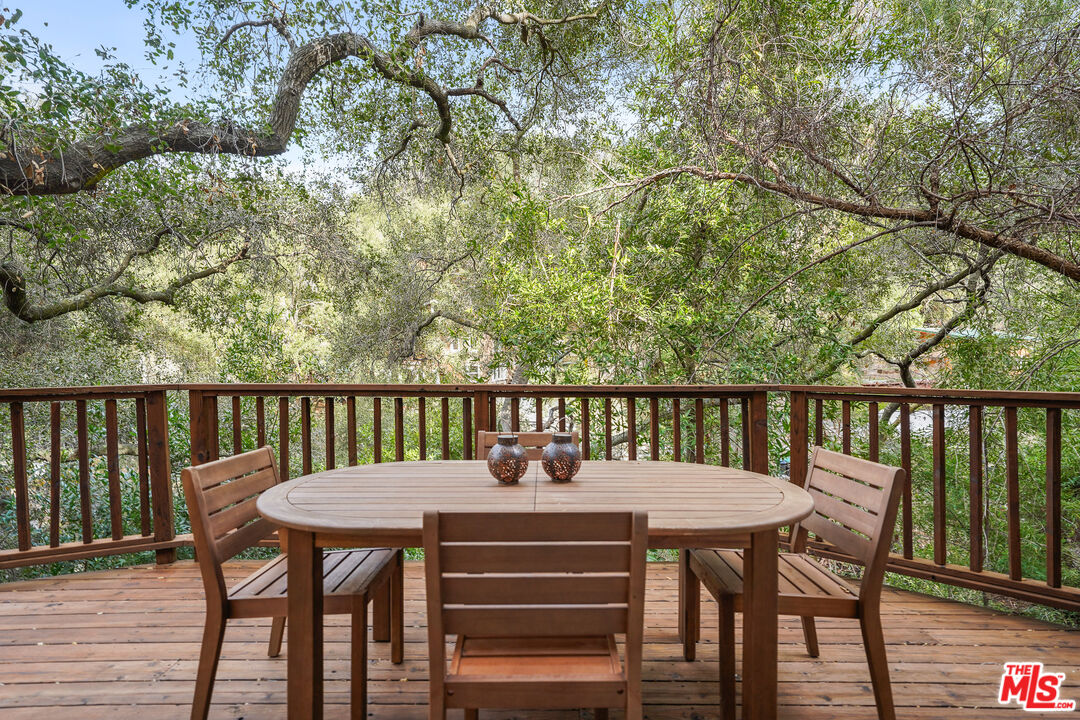 21545 Dome Trail Topanga, CA 90290 - Photo 8 of 23 a view of a balcony with table and chairs