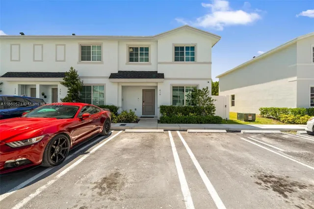 a car parked in front of white house