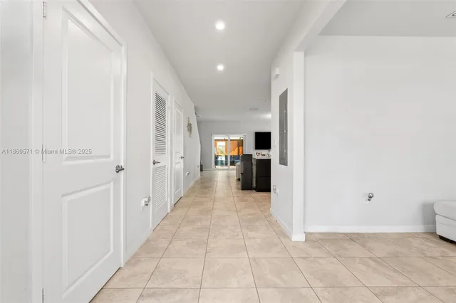 a view of a hallway with a kitchen