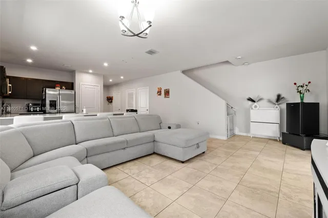 a living room with furniture and kitchen view