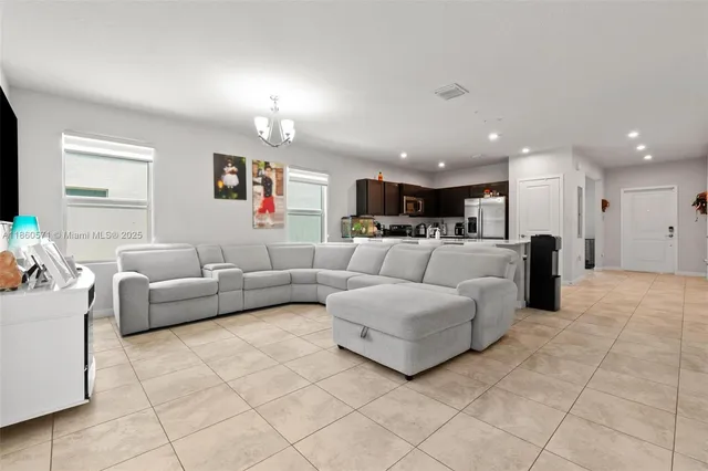 a living room with furniture and a chandelier