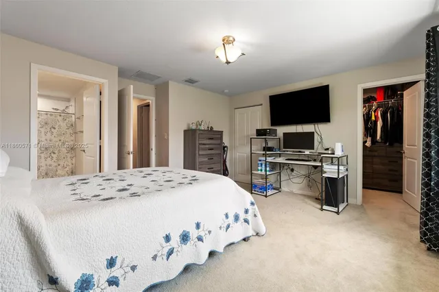 a bedroom with a bed and flat screen tv