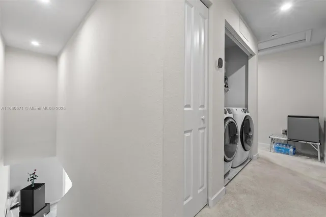 a view of a storage and utility room with a washer dryer