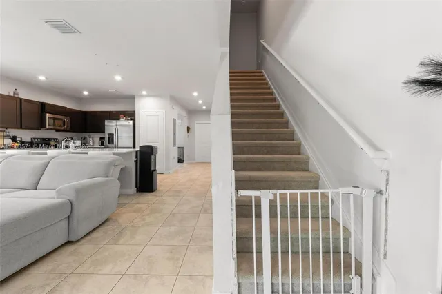a living room with furniture and kitchen view