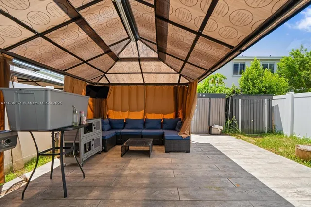 a view of backyard with a patio and a garden