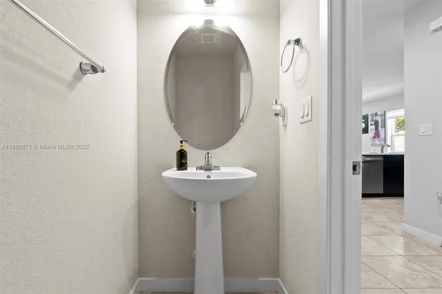 a bathroom with a sink and mirror