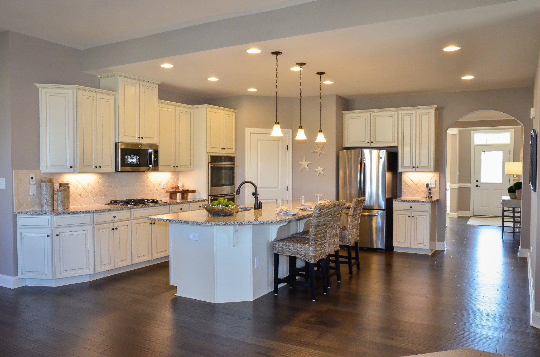 4020 Oglethorpe Drive Franklin, TN 37064 - Photo 13 of 14 a kitchen with stainless steel appliances kitchen island granite countertop a stove top oven a sink a refrigerator and white cabinets with wooden floor