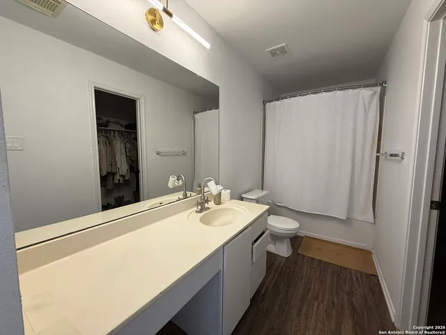 a bathroom with a sink a toilet and mirror
