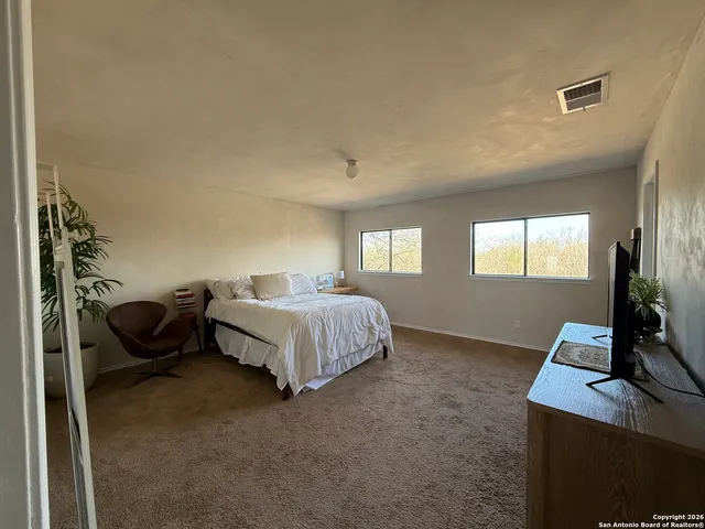 a bedroom with a bed and window