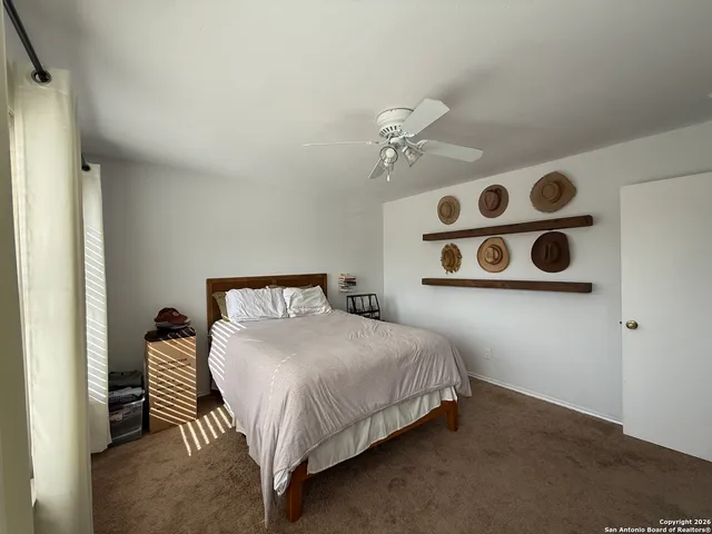 a bedroom with a bed and a wall painting