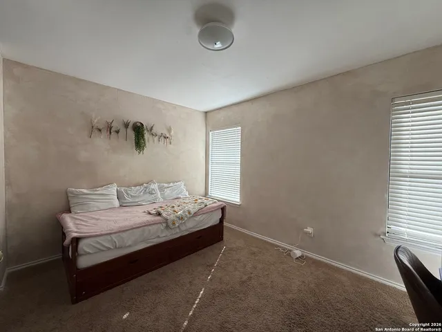 a bedroom with bed and window