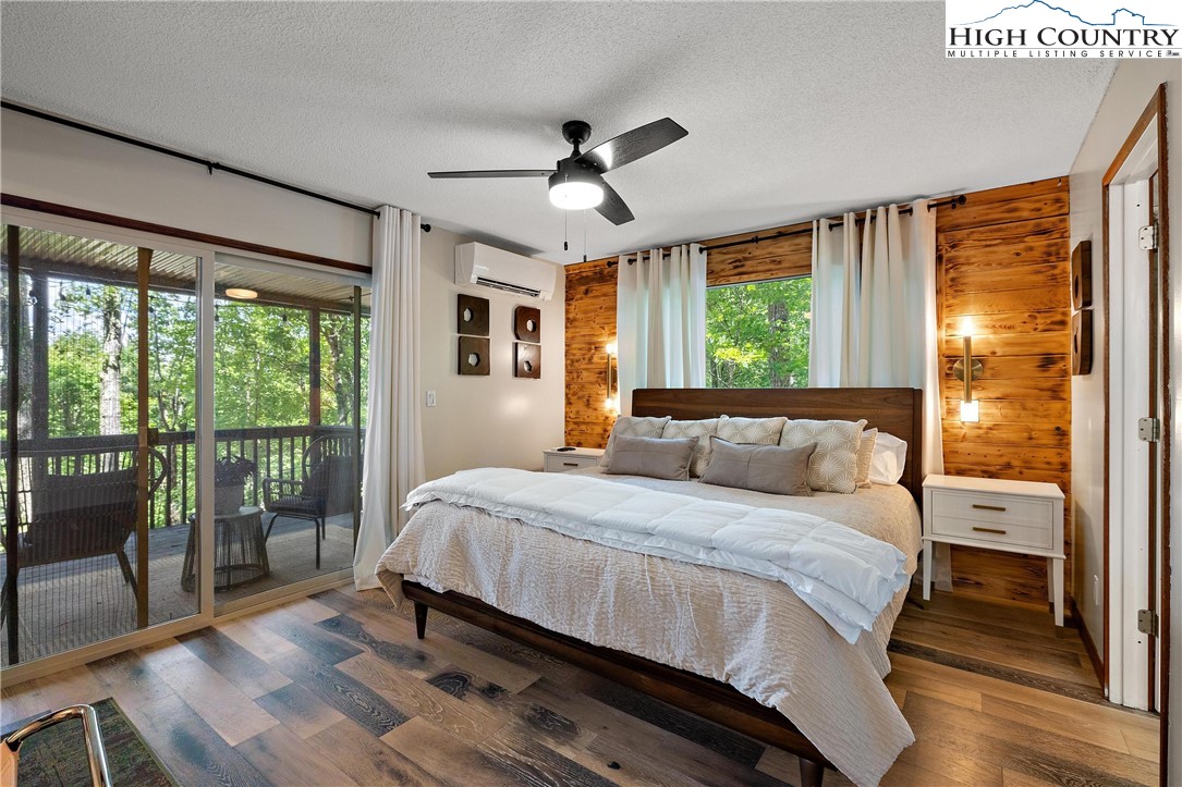 139 Club House Road Beech Mountain, NC 28604 - Photo 12 of 44 a bedroom with a large bed and a large window