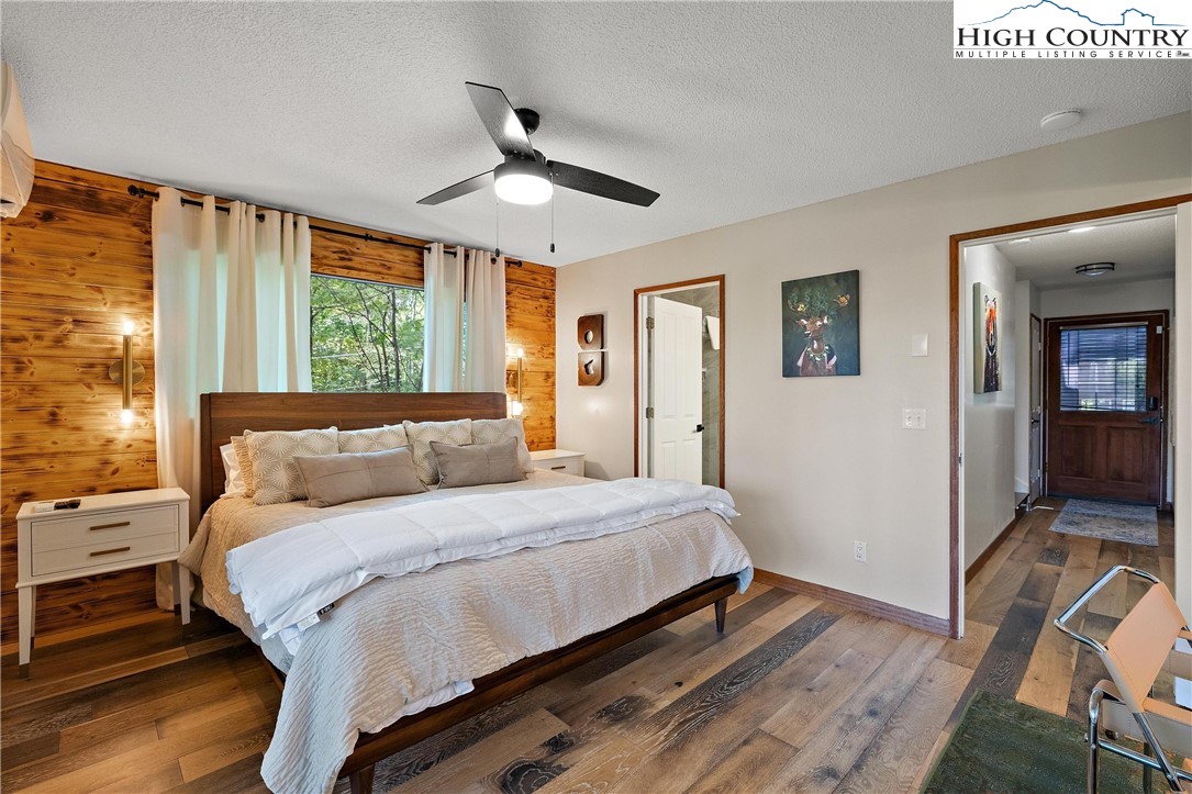 139 Club House Road Beech Mountain, NC 28604 - Photo 15 of 44 a bedroom with a bed and wooden floor