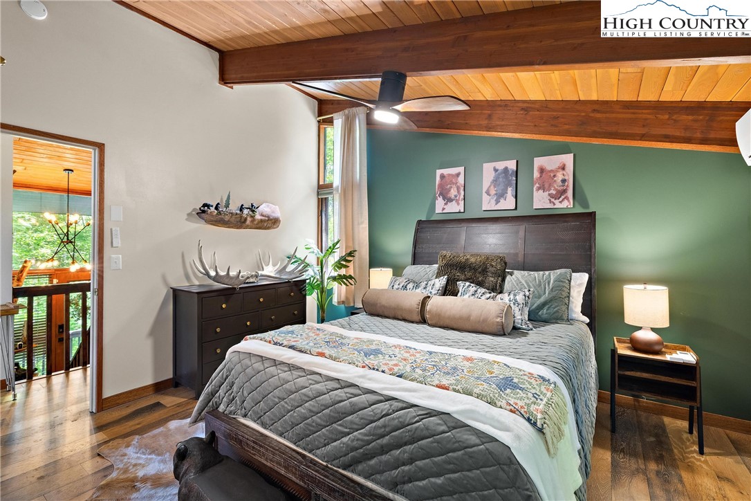 139 Club House Road Beech Mountain, NC 28604 - Photo 22 of 44 a bedroom with a bed and a lamp on dresser