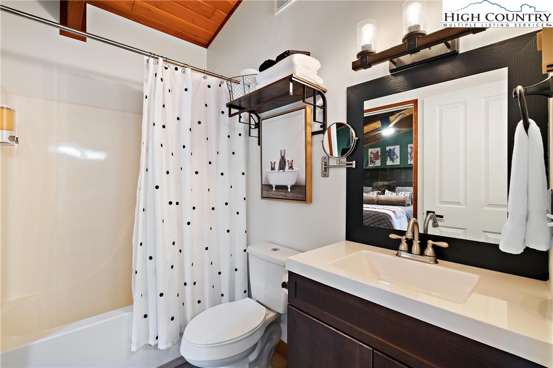 139 Club House Road Beech Mountain, NC 28604 - Photo 23 of 44 a bathroom with a sink a toilet a shower and a mirror