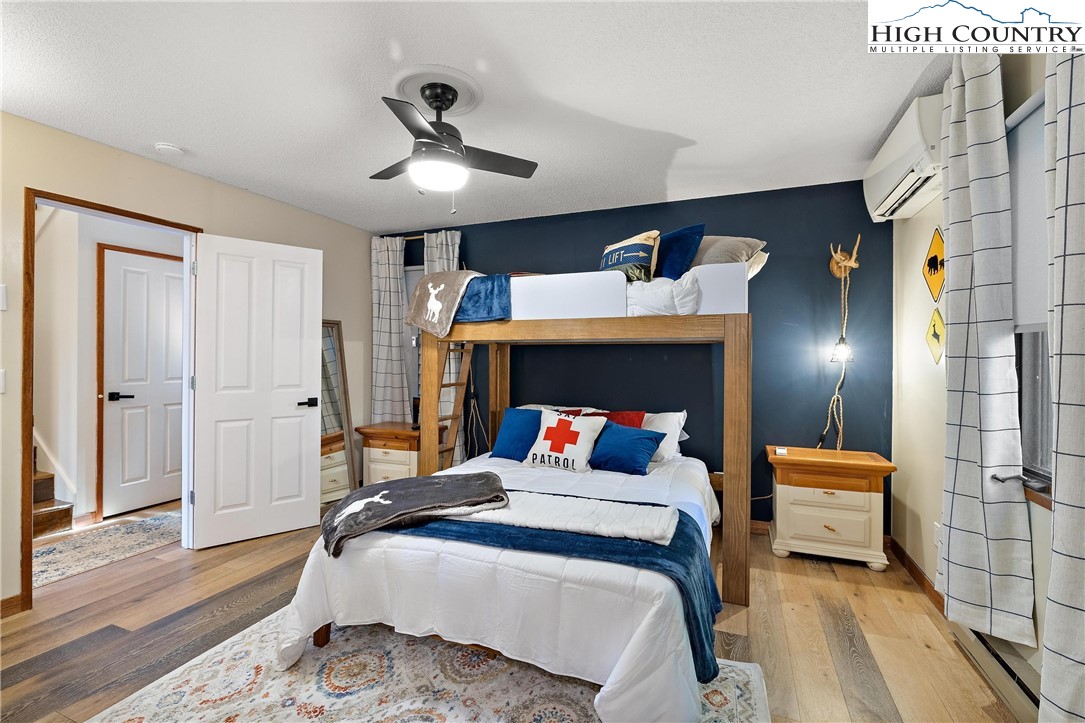 139 Club House Road Beech Mountain, NC 28604 - Photo 28 of 44 a bedroom with a bed and a chandelier
