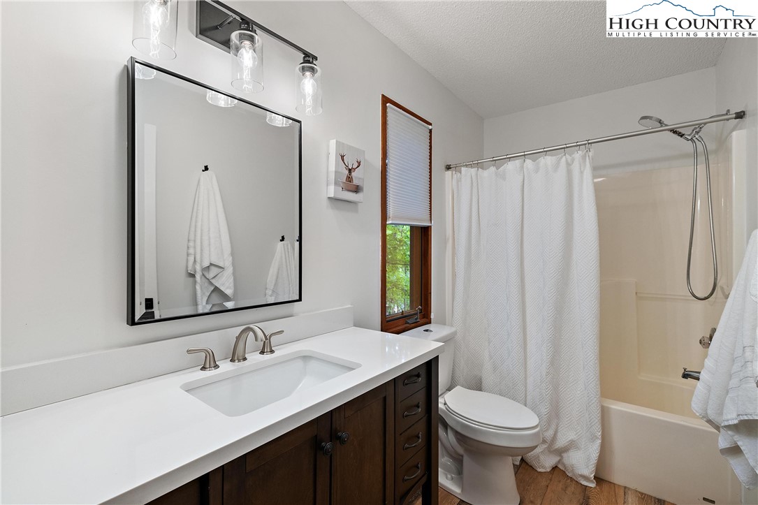 139 Club House Road Beech Mountain, NC 28604 - Photo 29 of 44 a bathroom with a sink toilet and shower