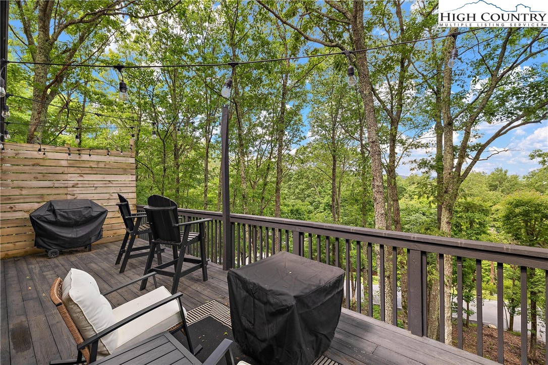 139 Club House Road Beech Mountain, NC 28604 - Photo 38 of 44 a view of a balcony with chair and potted plants