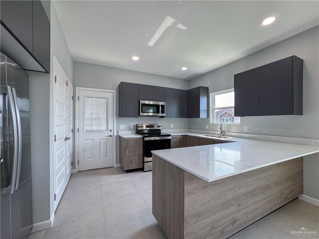 2705 Robin Road Weslaco, TX 78596 - Photo 3 of 8 a large kitchen with stainless steel appliances lots of counter top space