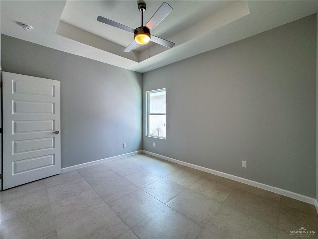 2705 Robin Road Weslaco, TX 78596 - Photo 5 of 8 an empty room with a ceiling fan and carpet