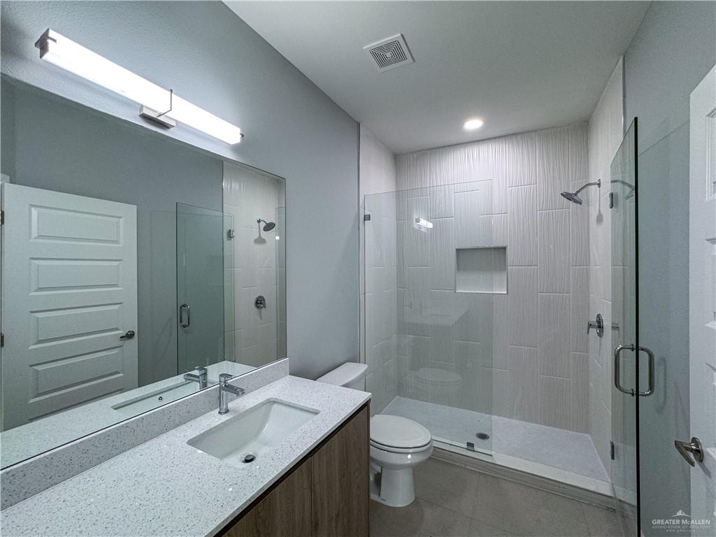 2705 Robin Road Weslaco, TX 78596 - Photo 6 of 8 a bathroom with a sink a toilet and shower