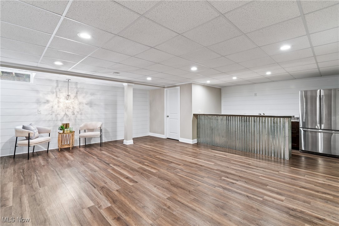 191 Ry Road Wadsworth, OH 44281 - Photo 20 of 34 Finished basement with freestanding refrigerator, recessed lighting, wood finished floors, wood walls, and a drop ceiling
