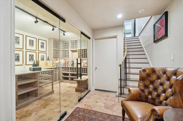 a living room with furniture fireplace and a large window